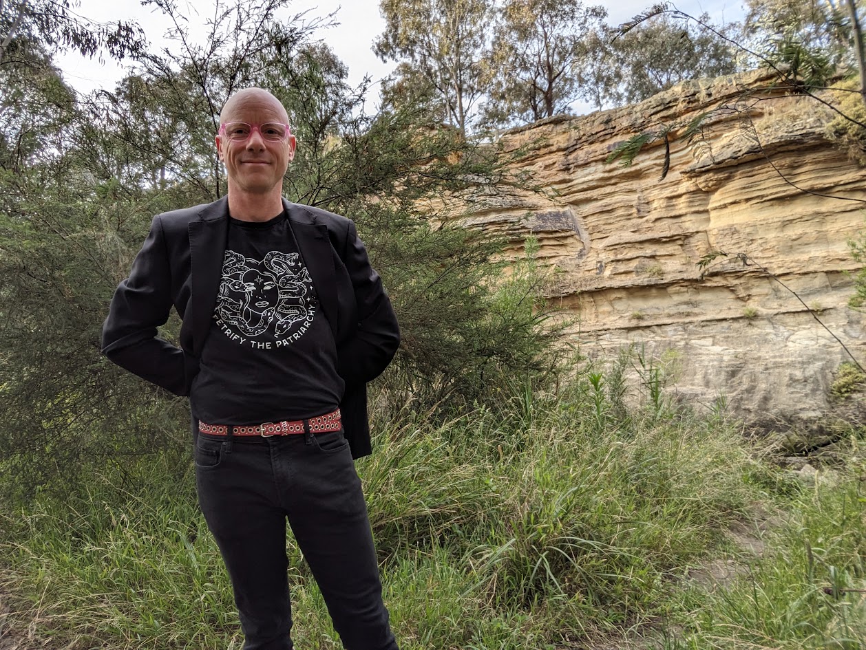 ADHD coach Mike Pulsford standing in front of a cliff in Melbourne